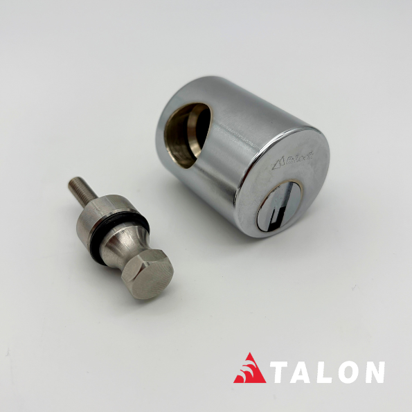 A chrome-finished cylindrical lock cylinder shown disassembled with its small matching bolt and washer on a clean white background. The TALON brand logo is visible in the bottom right corner.